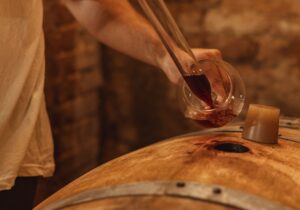 wine tours tuscany spilling wine from the barrel 