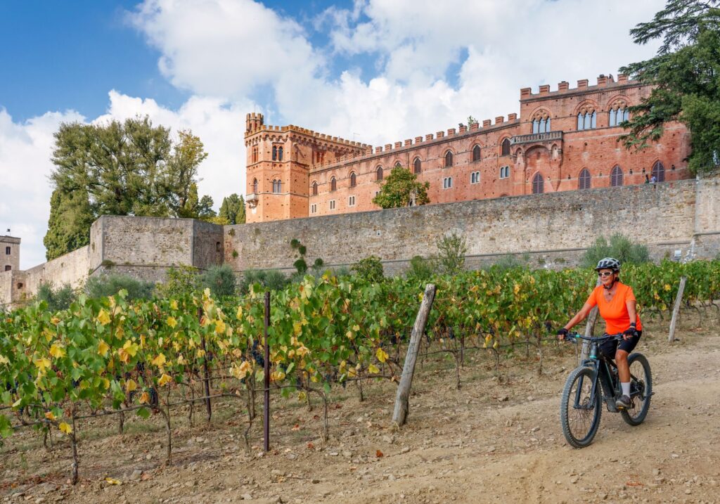 woman riding ebike in the vineyards wine tour tuscany