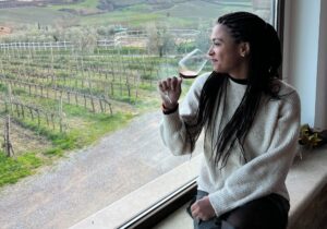 girl sipping wine wine tour montepulciano window view