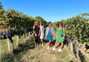 girls in the vineyard during wine tour ripe grapes