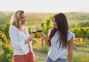 wine tour tuscany toasting laughing